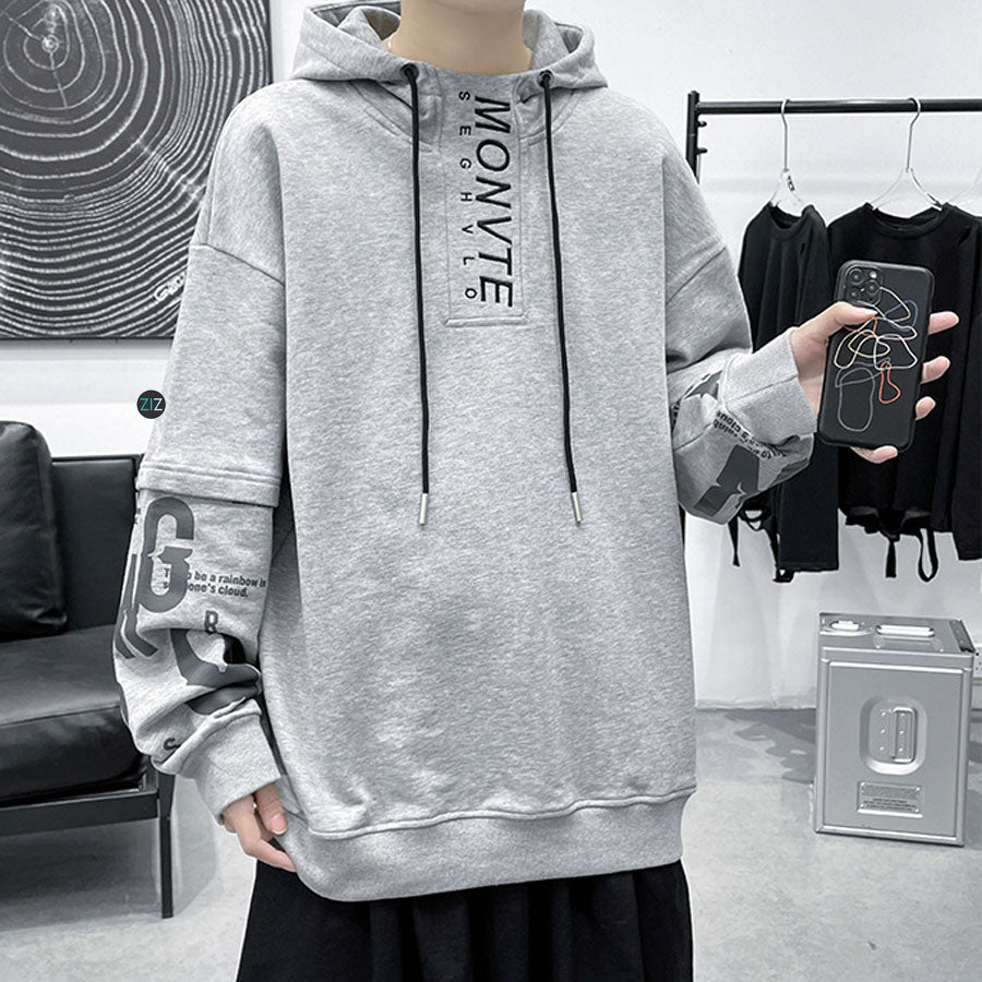 Thiết kế hoodie màu xám với mũ và dây rút, chi tiết chữ in cá tính, mang đến phong cách street style hiện đại, dễ phối đồ