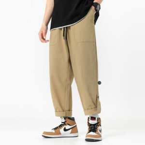 Quần Kaki Baggy Nam Nữ màu be phong cách streetwear cá tính, thiết kế ống quần suông rộng với dây rút và gấu quần gấp lên
